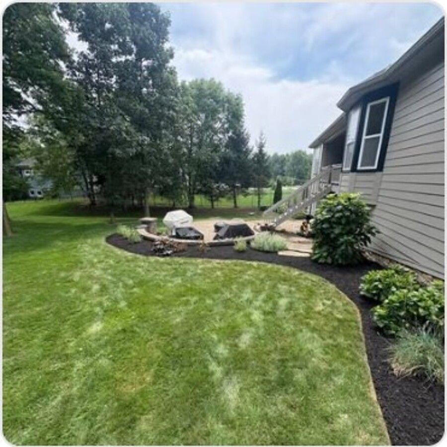 Curved mulch bed edging along a walkway