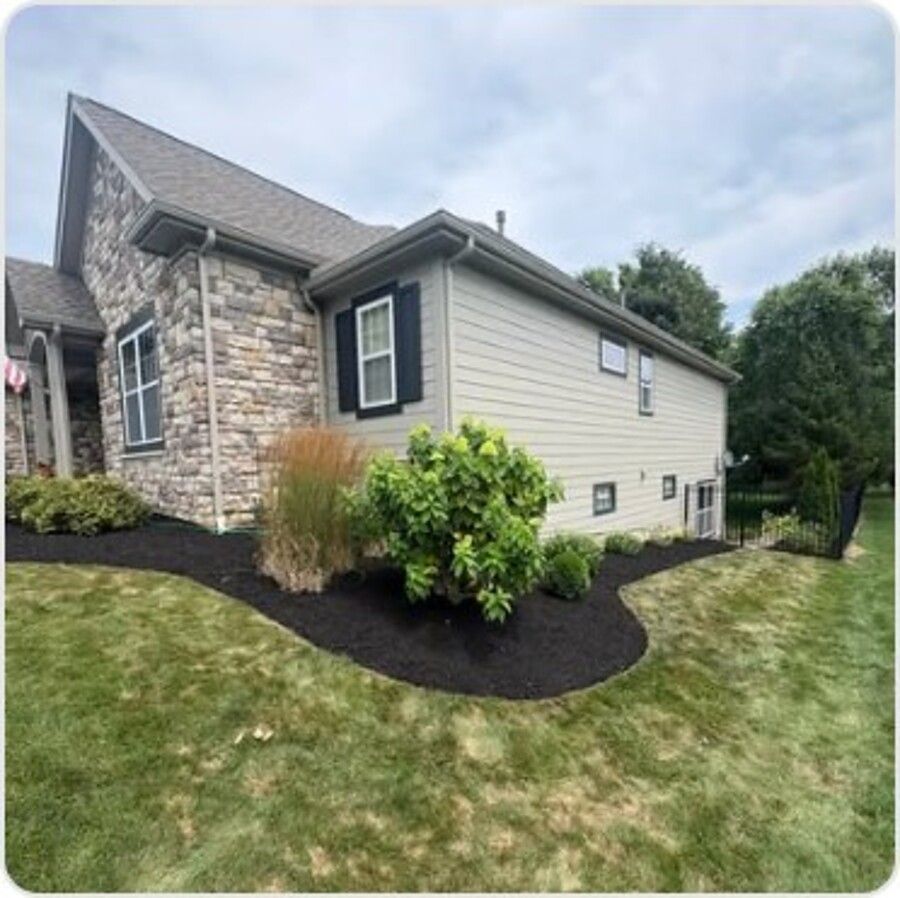 Fresh mulch bed curve beside a home