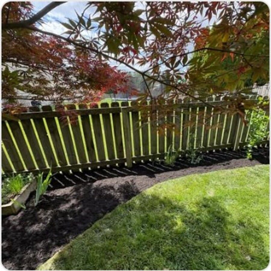 Landscape bed along a wrought iron fence