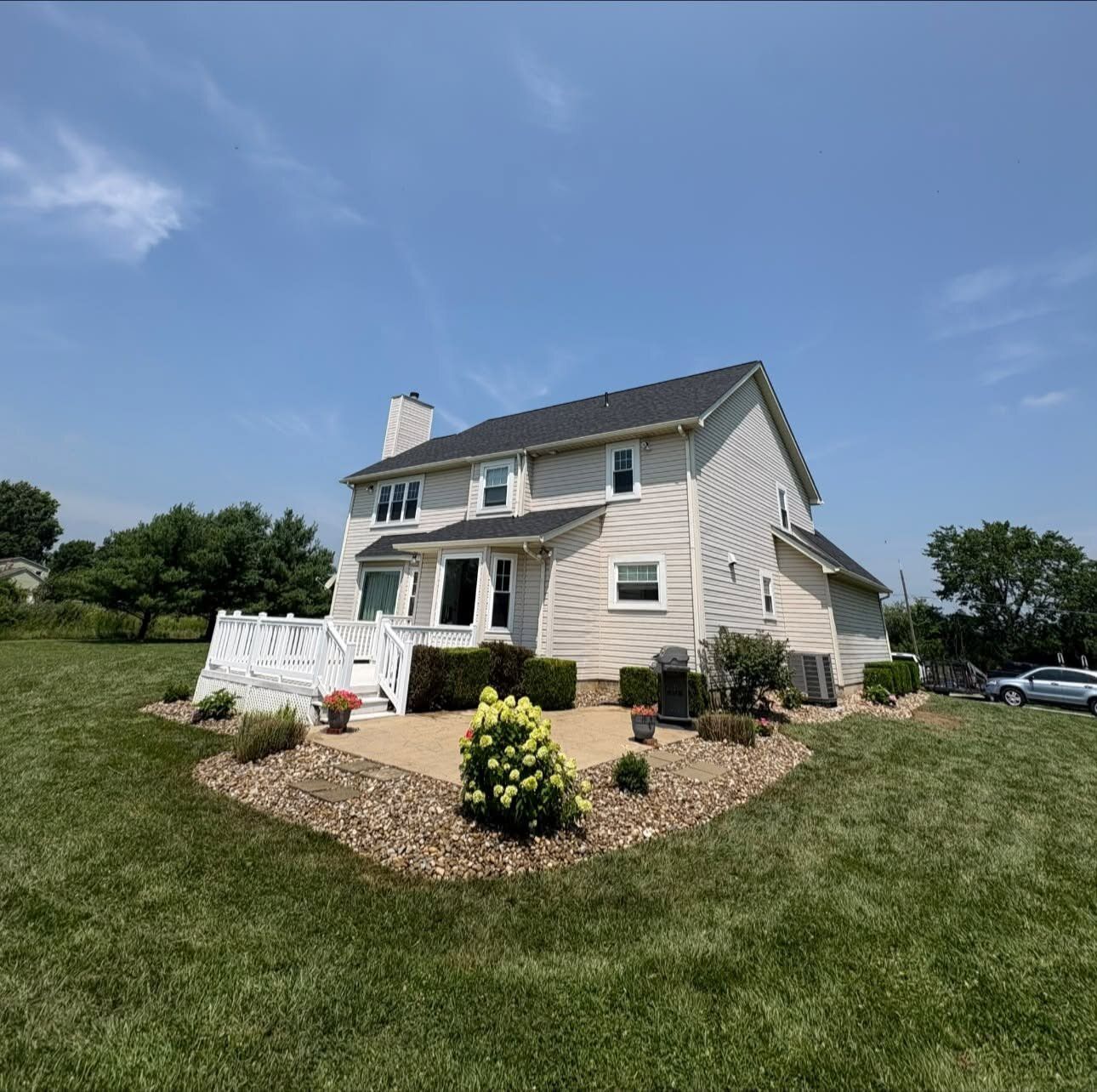 Fresh mulch beds and shrubs with hand-cut edging along a home